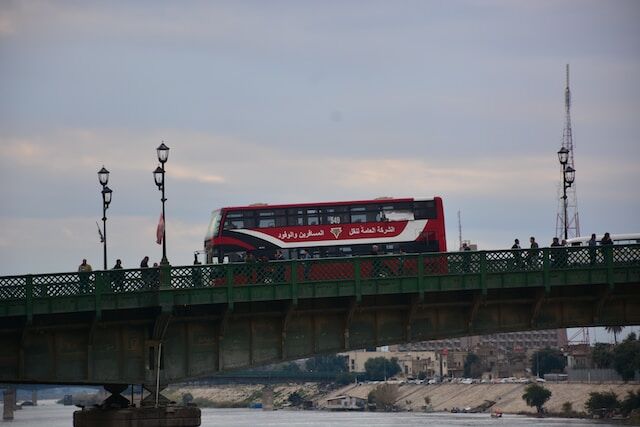 Red double decker bus is part of transportation business's fleet